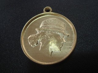 Metal pendant with a portrait