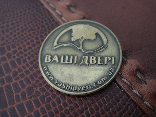 brass shields with the logo on the door