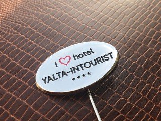 metal pins with the "hotel yalta intourist" logo
